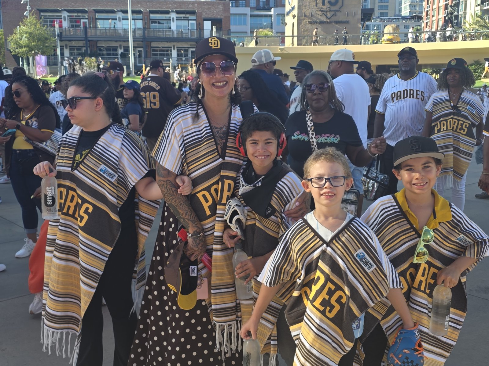 Family in custom Padres ponchos at African American Heritage Night